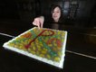 conservation assistant mary girerd with jelly bean chi-ro symbol which features on the stained glass panel